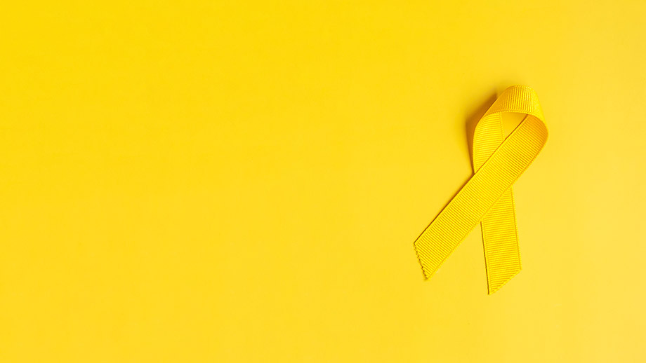 Gelbe Suizid-Präventions-Schleife auf gelbem Hintergrund