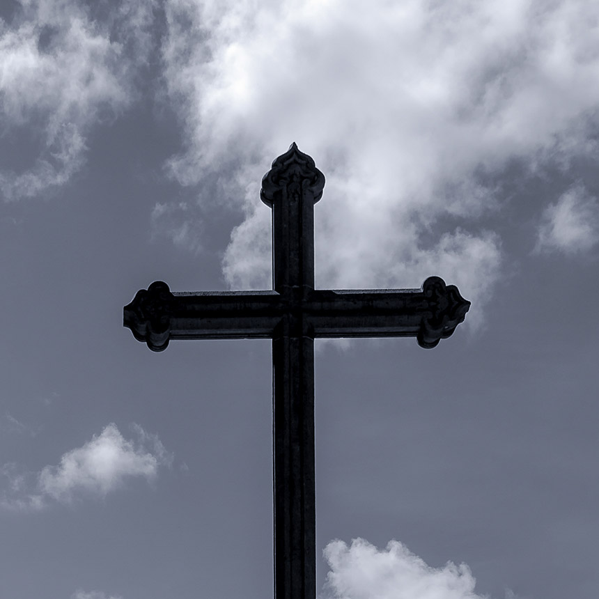 Church cross with dark clouds