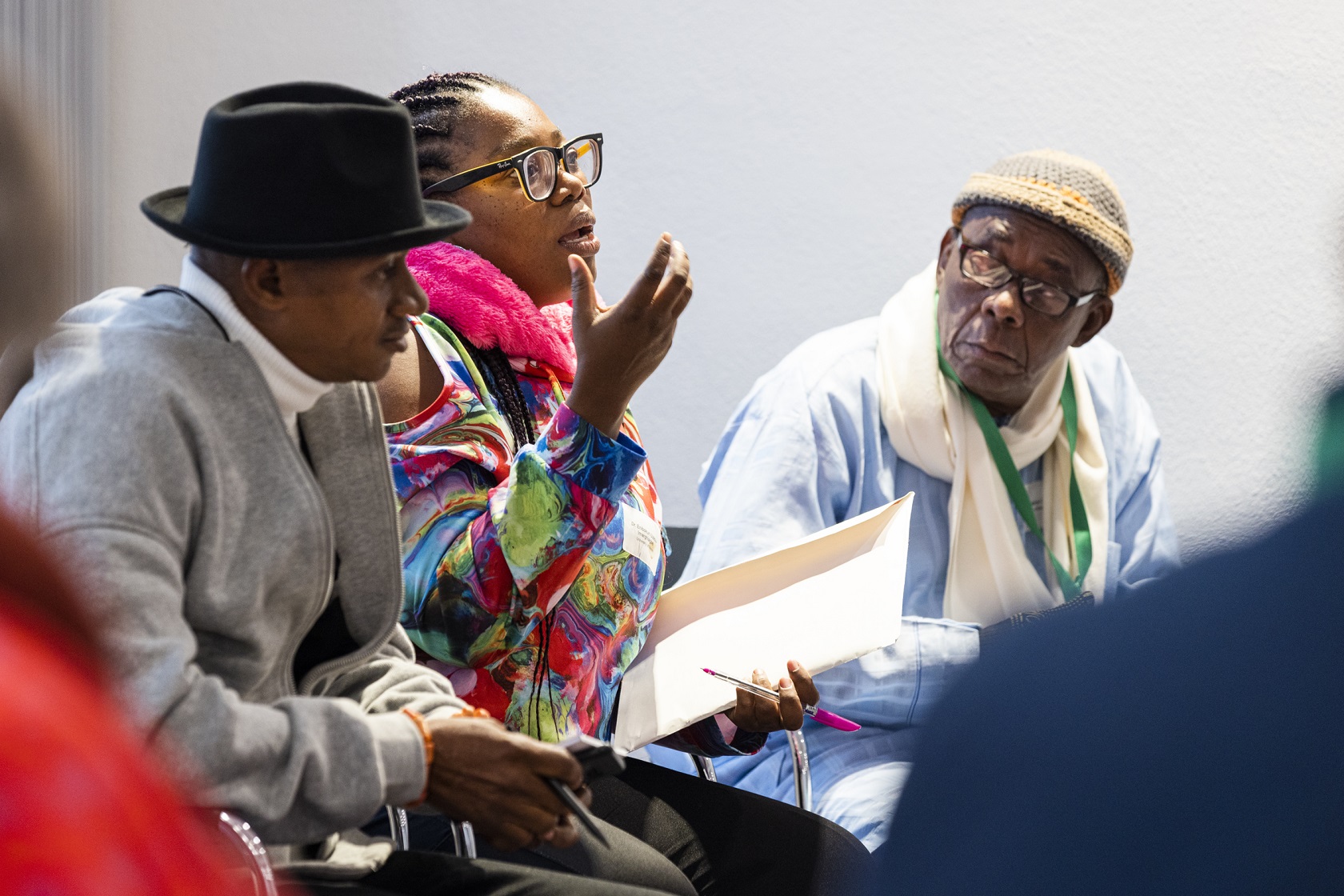 Researchers Enibokun Uzébu-Imarhiagbe in conversation with art historian Patrick Oronsay and bronze caster Phil Omodamwen.